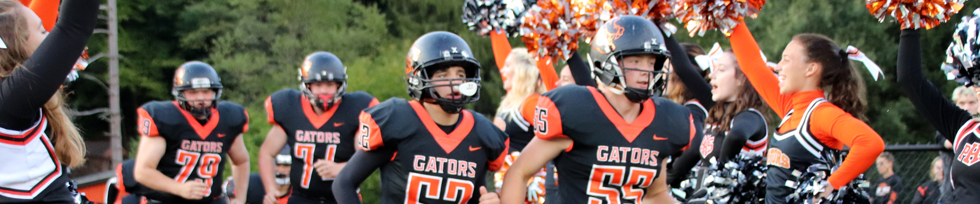 group of football players running onto the field